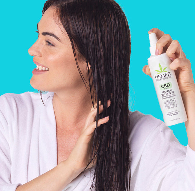 Model spraying hair with CBD Leave-In Conditioner